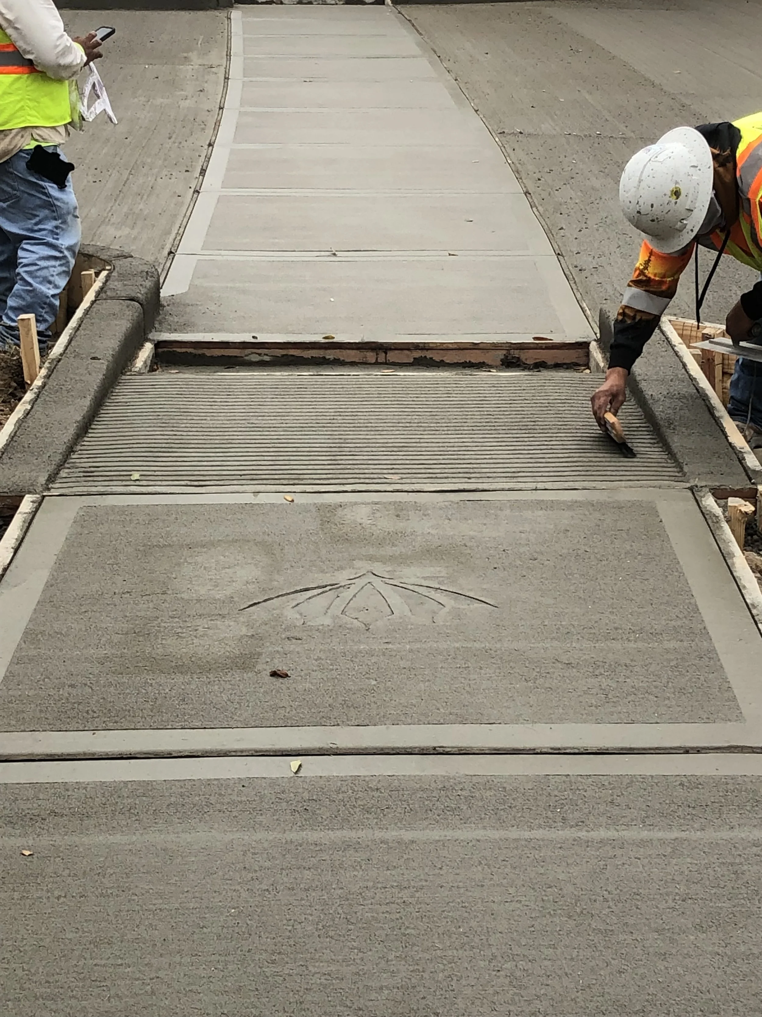 Concrete workers finishing a sidewalk